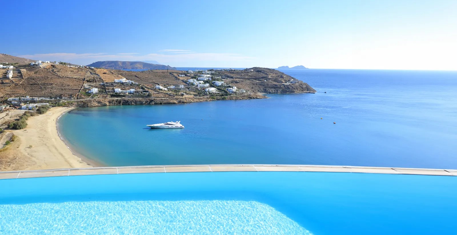 Authentic panoramic view from the villa over Kalo Livadi, infinity pool and Aegean bay